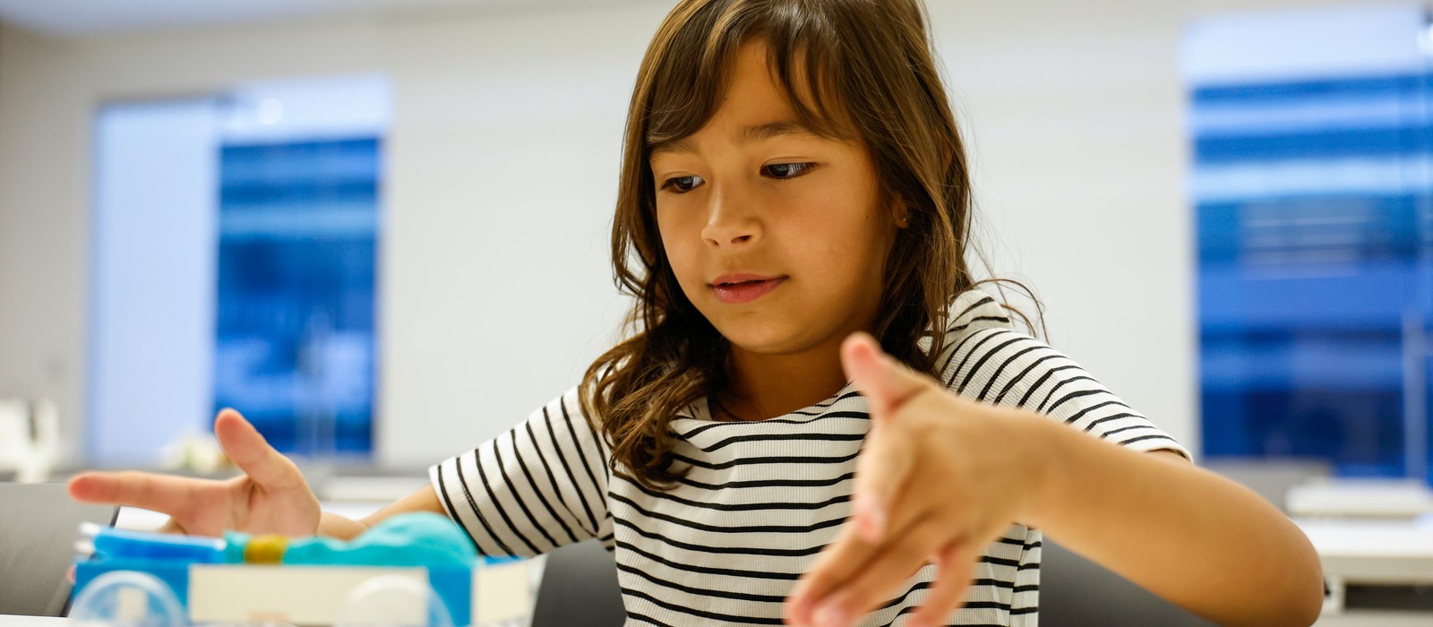 A student tests the model car she built during the Future Innovators Initiative with Hyundai.